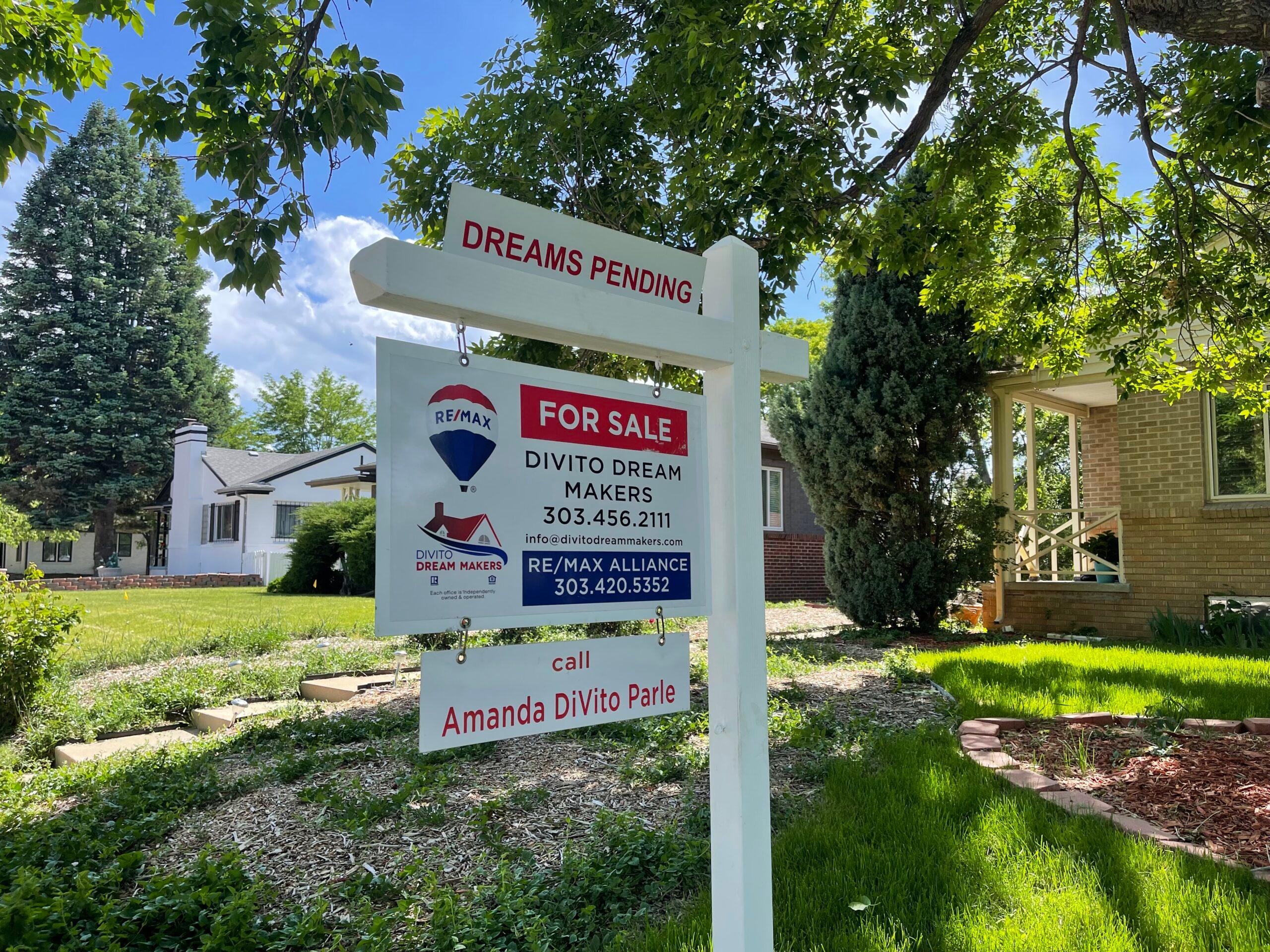 A real estate sign in Park Hill states "Dreams Pending."