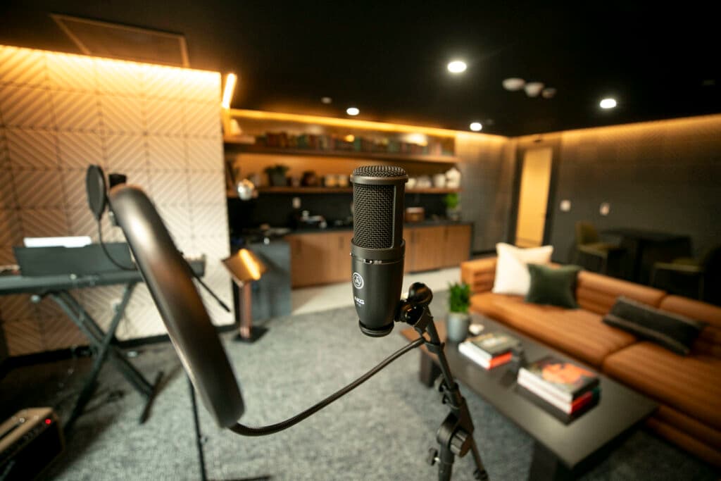 A studio microphone is set up in a warm-toned room.