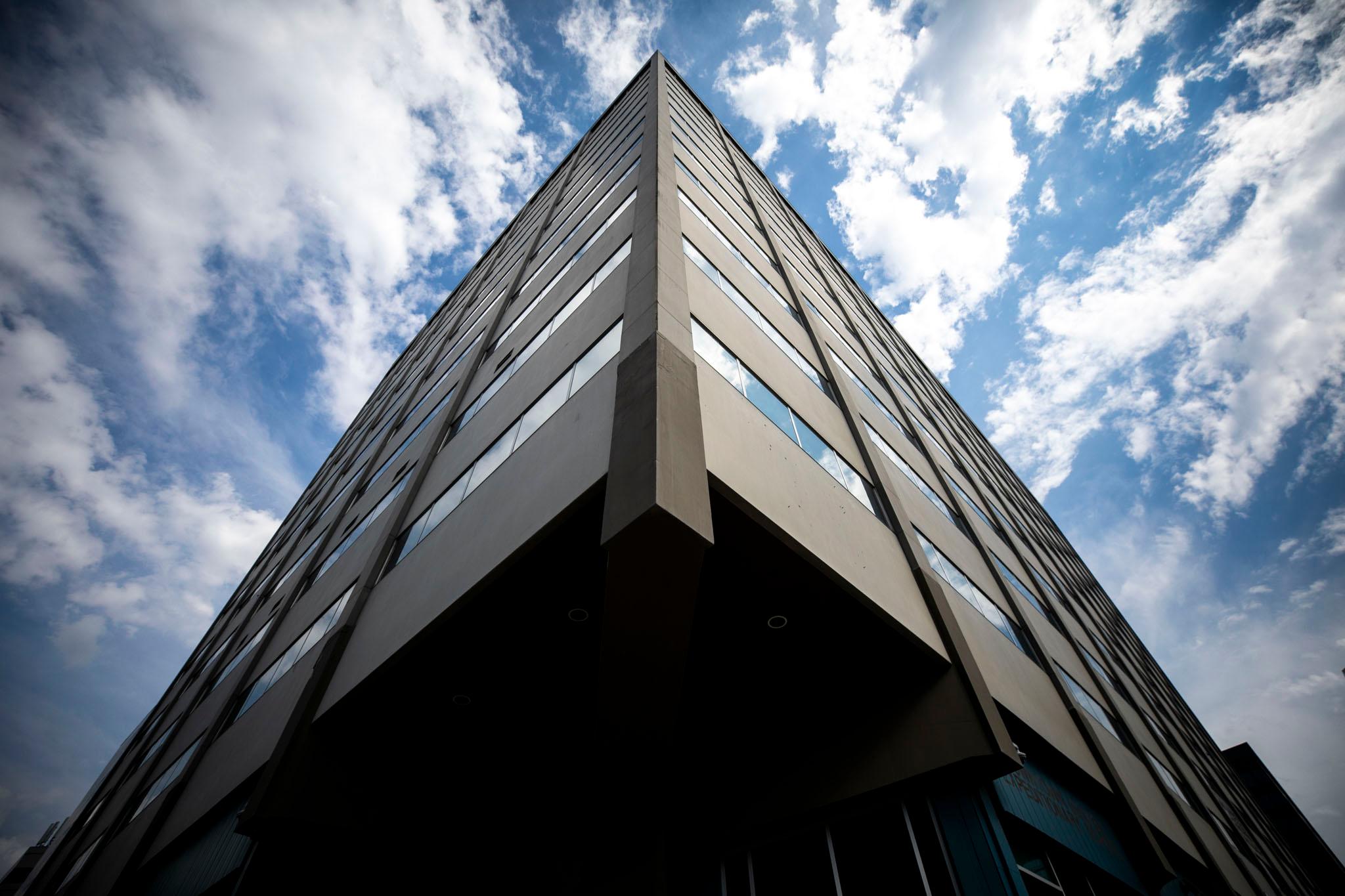 A slate building rises towards blue skies.