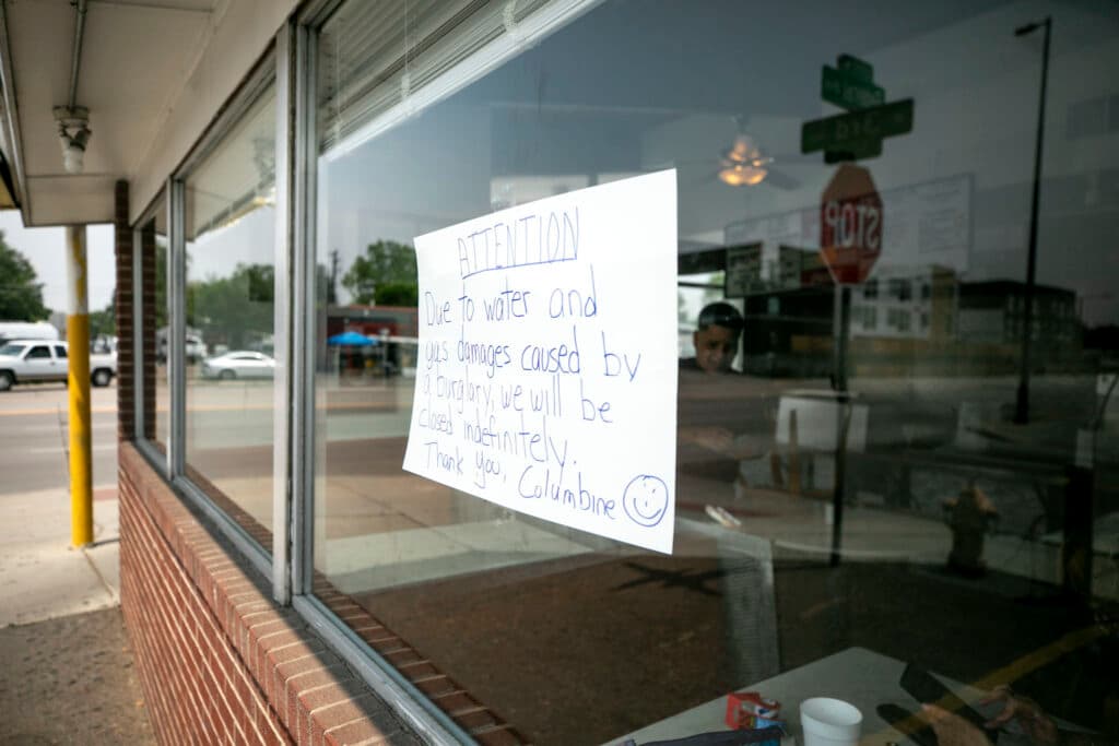 A sign on a window reads, &quot;ATTENTION, Due to water and gas damages caused by a burglary, we will be closed indefinitely.&quot;