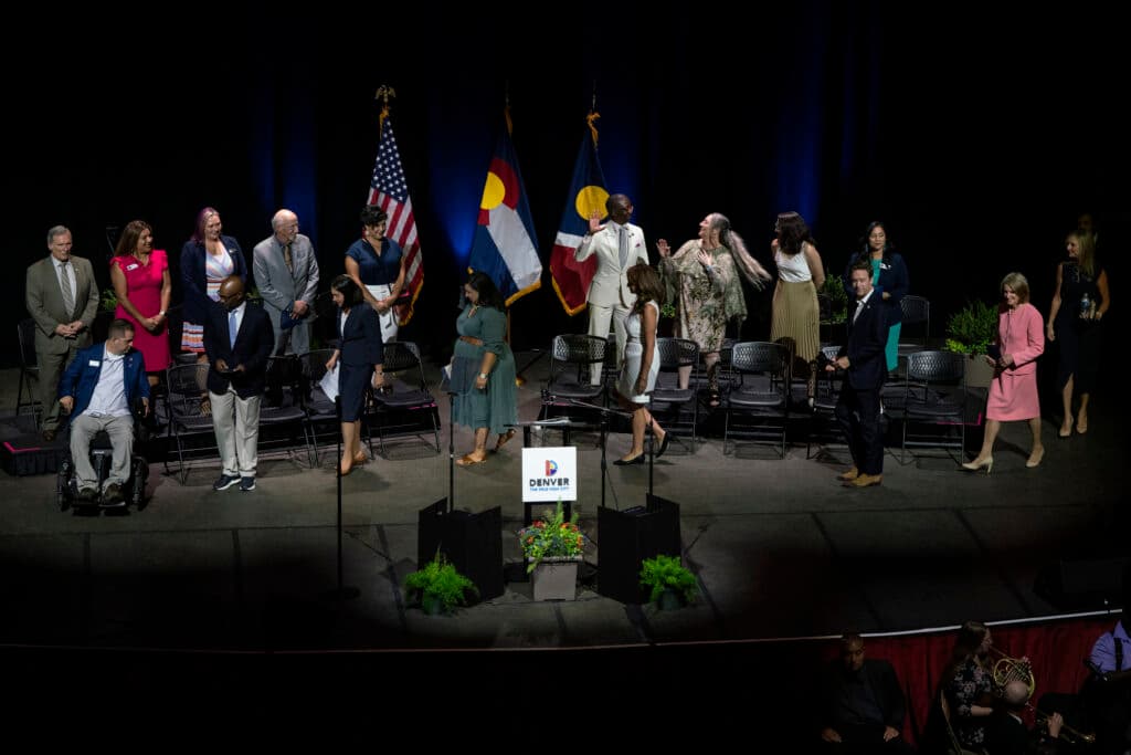 Mayor Mike Johnston and other City of Denver officials walk onstage and take their seats before the State of the City.