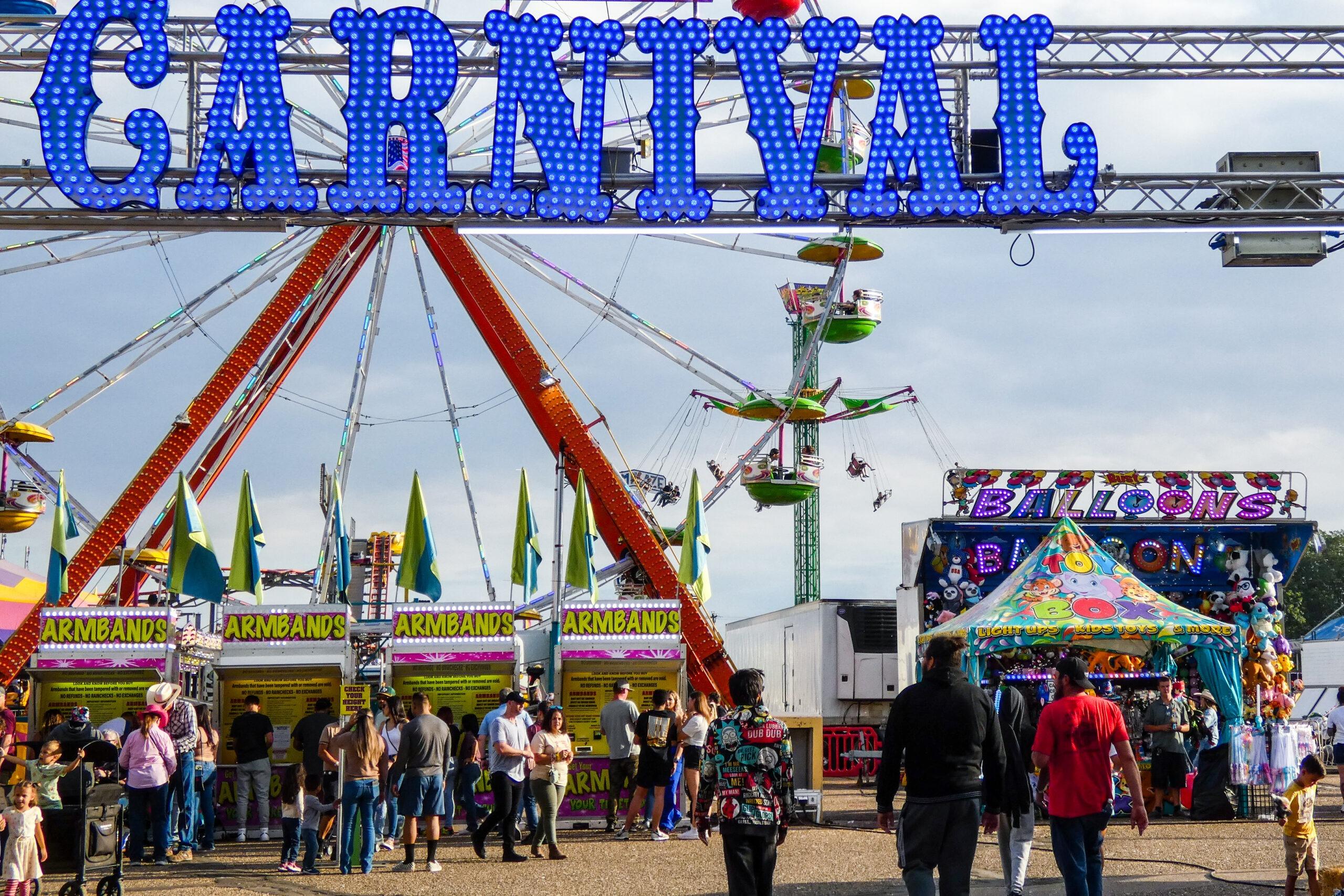 People entering the carnival portion of the Colorado State Fair.