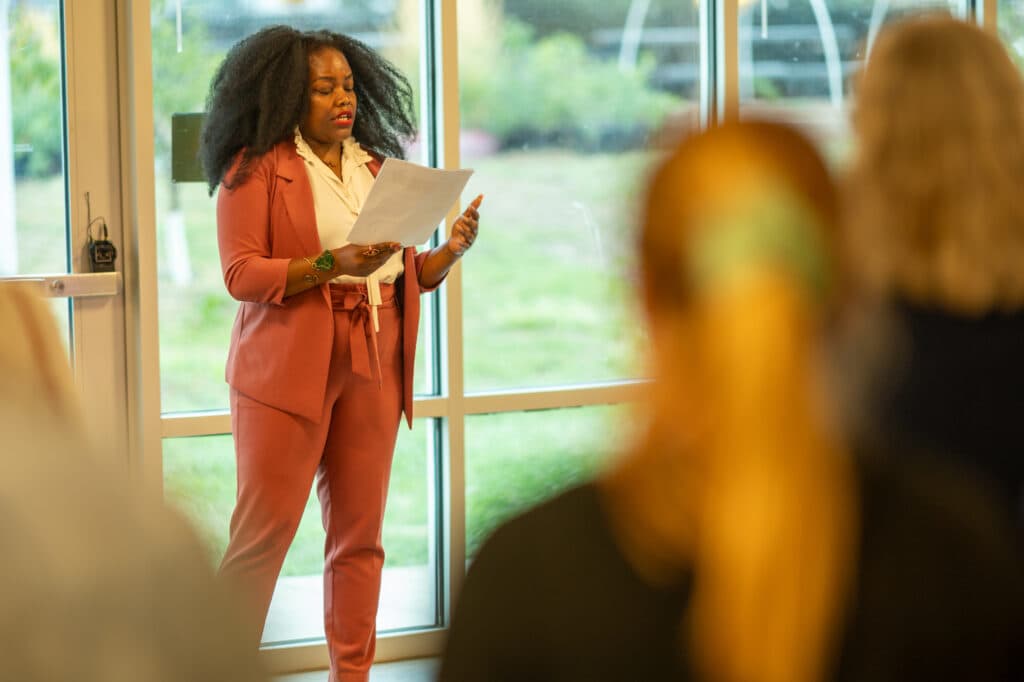 Councilmember Shontel Lewis speaks indoors at an event celebrating the opening of the yurt.