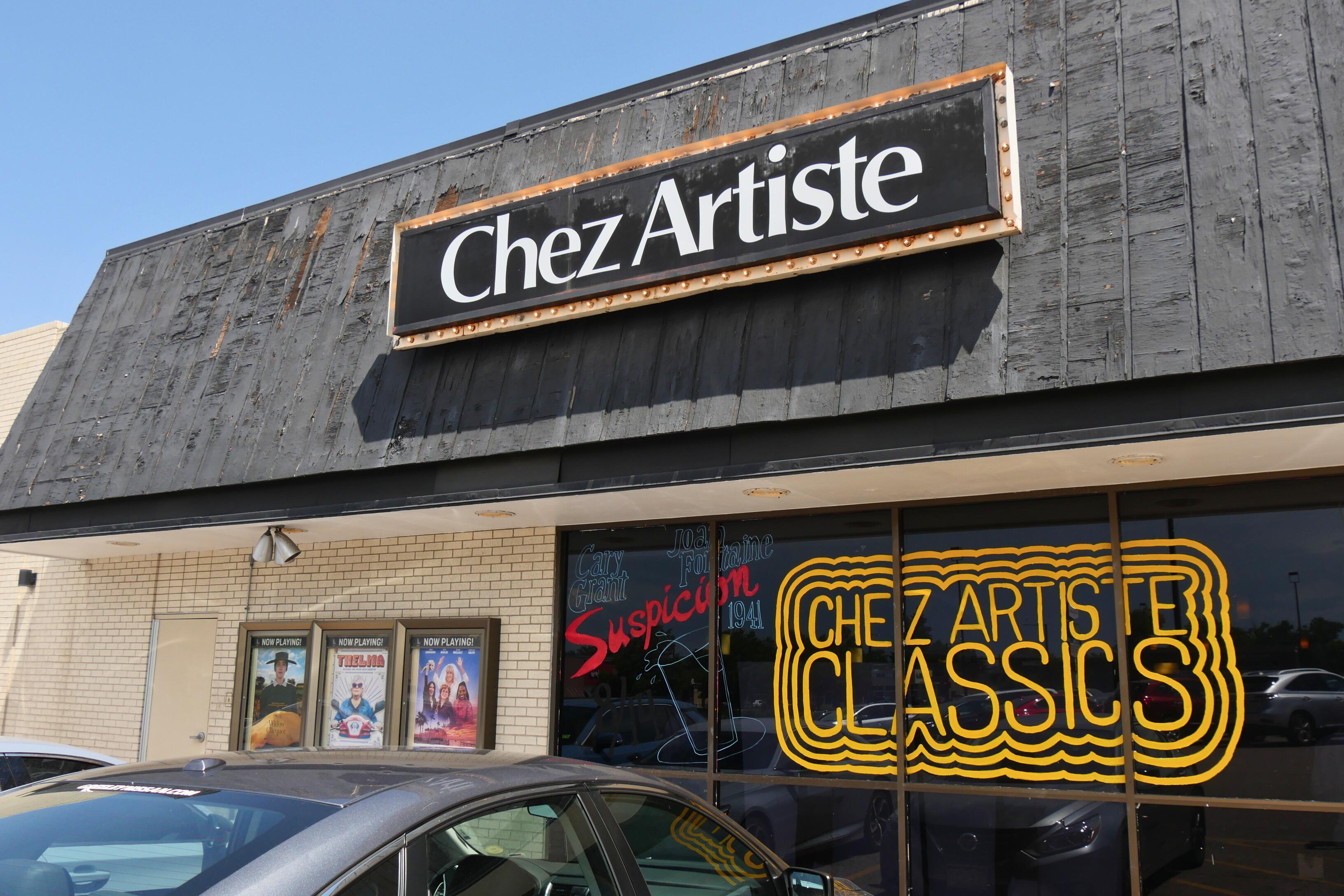 The exterior of the Chez Artiste Theatre on closing week, Aug. 5, 2024. The window reads, "Chez Artiste Classics" in yellow paints and movie posters are displayed in glass cases.