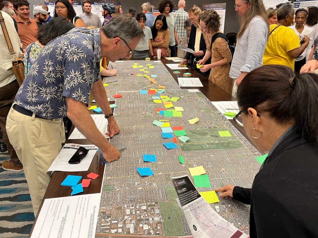 People place notes on a map.