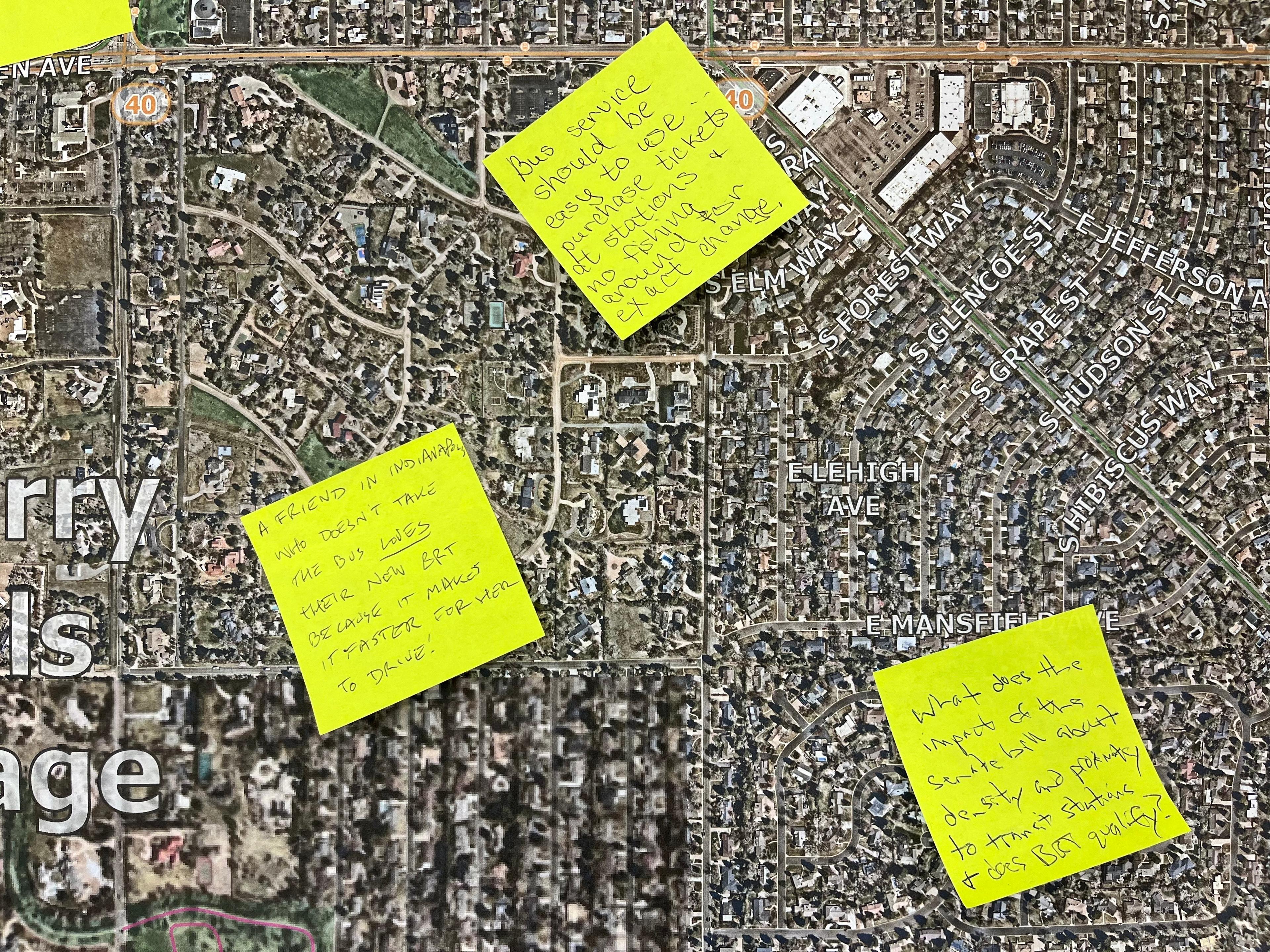 Post-it notes are stuck on a satellite image of a Denver neighborhood