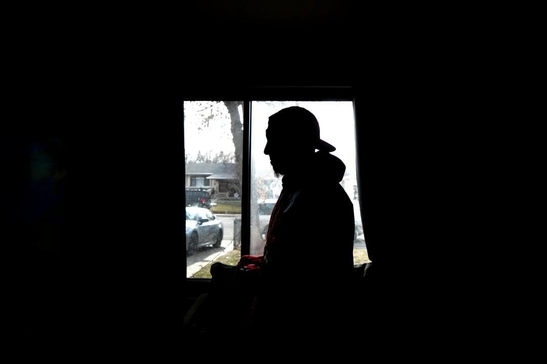 Silhouette of a man in front of a window