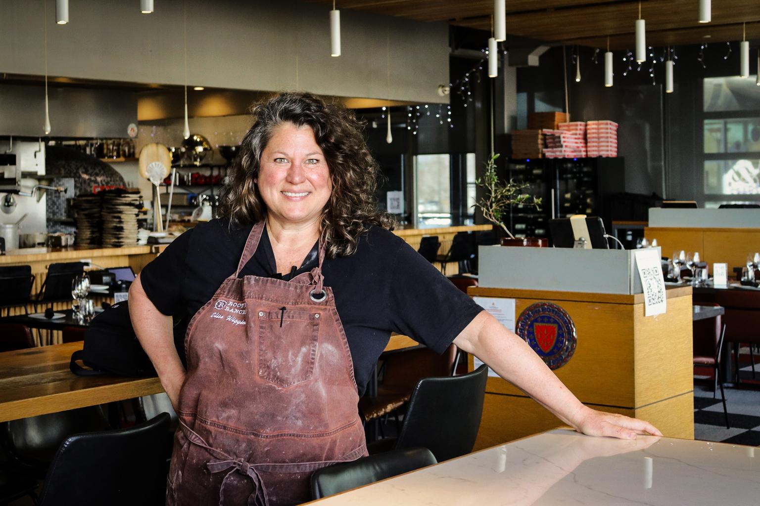 Elise Wiggins stands in the exhibition kitchen of her Cattivella Wood-Fired Italian restaurant.