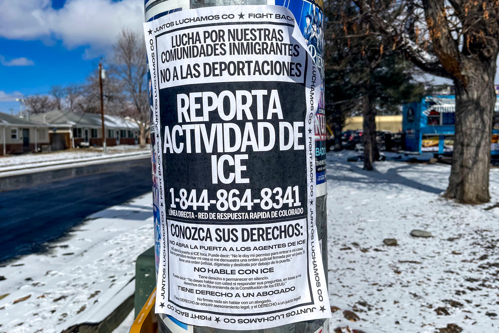 A sign on a street lamp encourages people to report ICE activity .