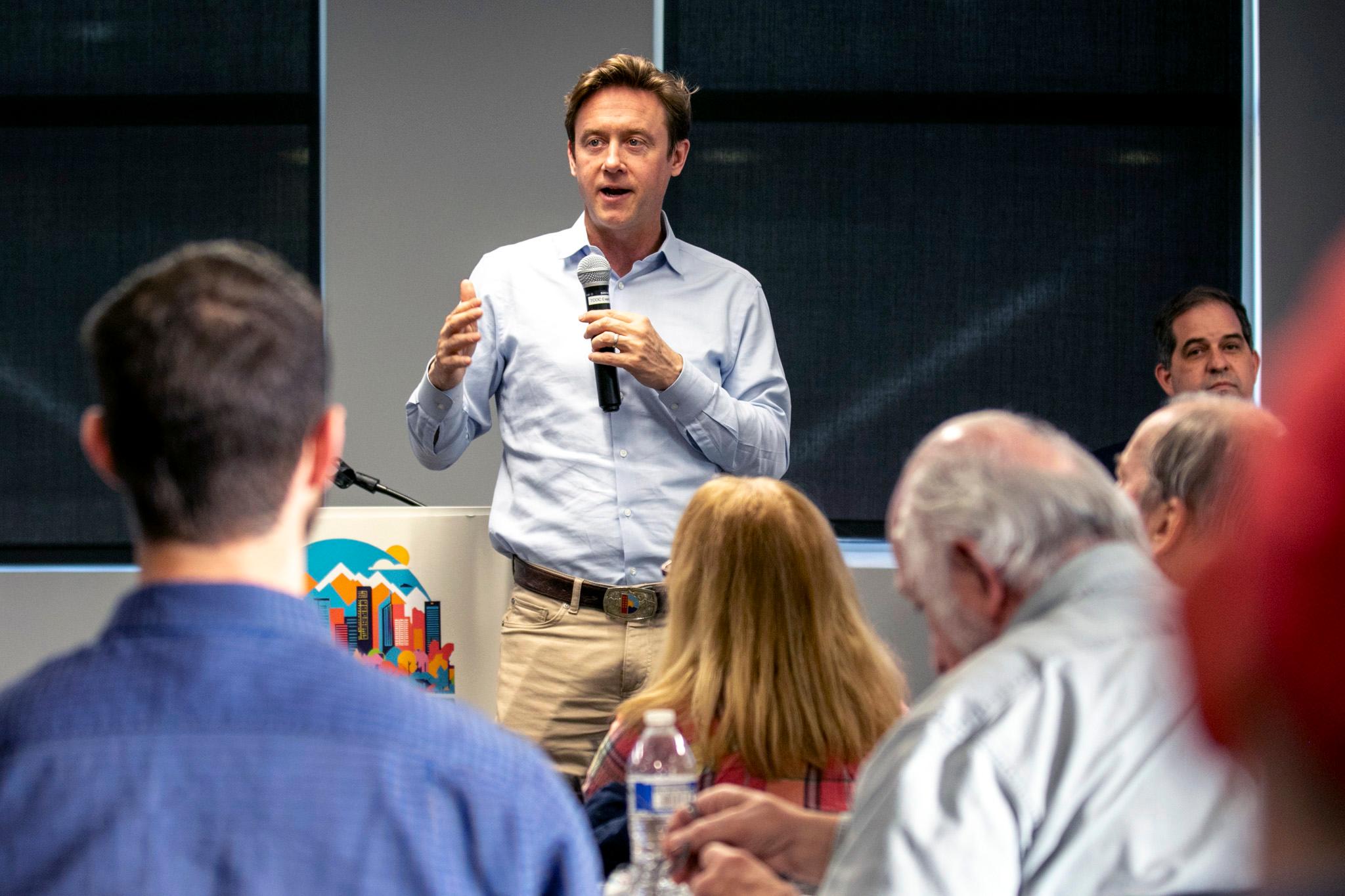 Mayor Mike Johnston speaks to a group
