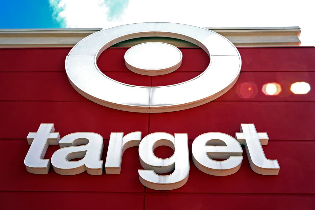 Looking up at the Target sign on the side of a red building.