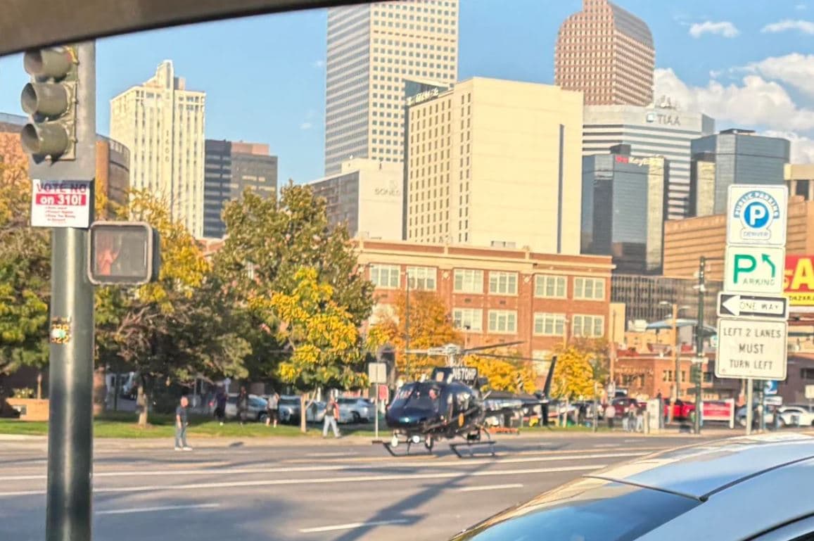 A city street with a helicopter parked in the middle of it.