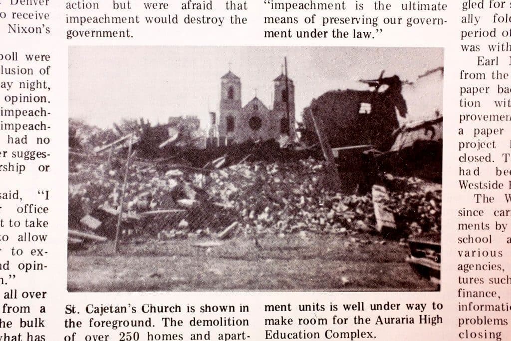 A black-and-white photo in a newspaper, showing St. Cajetan Catholic Church standing alone amid rubble.