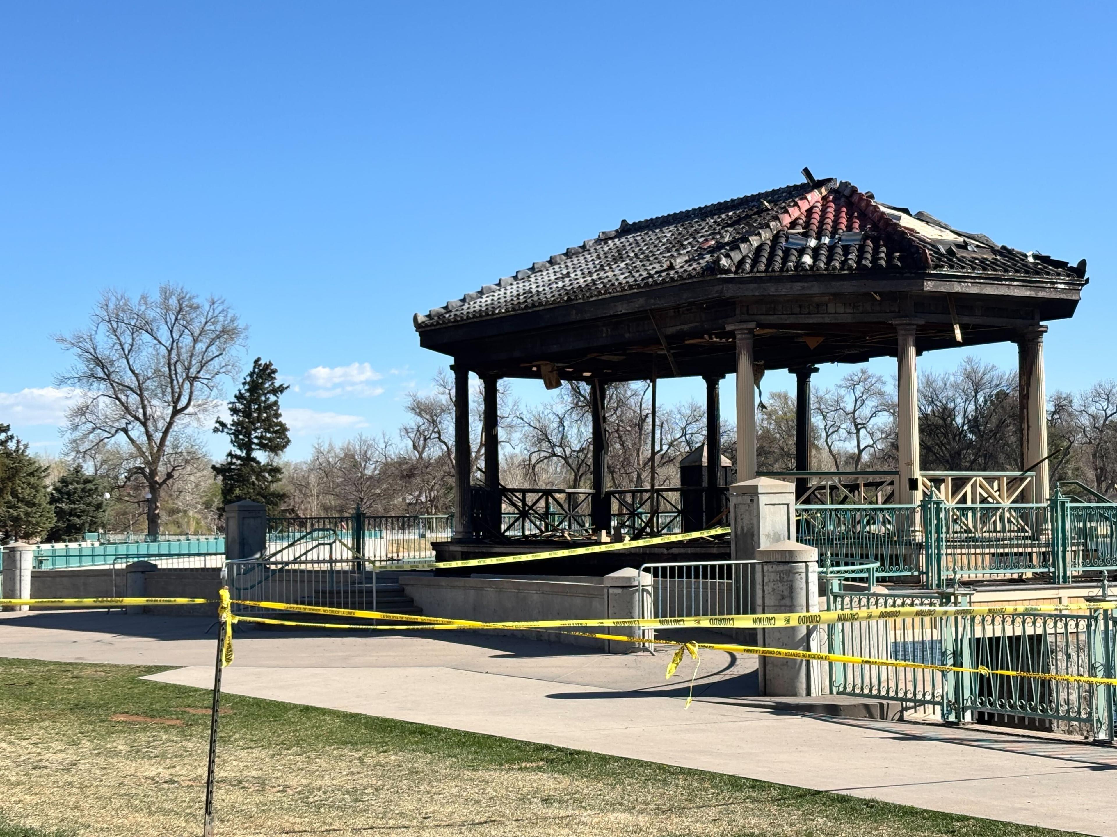 A bandstand structure is shown with fire damage to its tiled roof and columns.